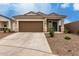 Inviting single-story home featuring a two-car garage and low-maintenance desert landscaping at 10347 S Saguaro Dr, Apache Junction, AZ 85120