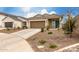 Inviting single-story home with a desert-style landscaped front yard and a blue front door at 10347 S Saguaro Dr, Apache Junction, AZ 85120