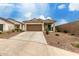 Inviting single-story home with a desert-style landscaped front yard and a blue front door at 10347 S Saguaro Dr, Apache Junction, AZ 85120