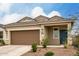 Close up of a home's front exterior including the two car garage and desert landscaping at 10347 S Saguaro Dr, Apache Junction, AZ 85120