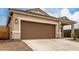 Close up of a home's front exterior including the two car garage and desert landscaping at 10347 S Saguaro Dr, Apache Junction, AZ 85120