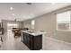 Open-concept kitchen island with seating and sink offers views into the living room at 10347 S Saguaro Dr, Apache Junction, AZ 85120
