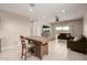 View of the living room and kitchen from the breakfast nook with natural light at 10347 S Saguaro Dr, Apache Junction, AZ 85120