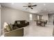 Inviting living room featuring tile floors, neutral walls and modern ceiling fan at 10347 S Saguaro Dr, Apache Junction, AZ 85120