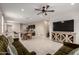 Open-concept living room and kitchen with neutral tones, tile floors, and ample natural light at 10347 S Saguaro Dr, Apache Junction, AZ 85120