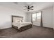 Spacious main bedroom with a large window, ceiling fan and soft, neutral carpet at 10347 S Saguaro Dr, Apache Junction, AZ 85120