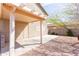 Covered back patio with decorative pergola and ample space for outdoor entertaining at 1037 E Dust Devil Dr, San Tan Valley, AZ 85143