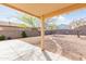 Shaded backyard with desert landscaping, brick accents and privacy walls surrounding at 1037 E Dust Devil Dr, San Tan Valley, AZ 85143