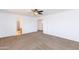 Bright bedroom with carpet, ceiling fan, and closet access, with ample room for storage at 1037 E Dust Devil Dr, San Tan Valley, AZ 85143
