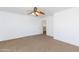 Large bedroom with neutral carpet, a ceiling fan, and a closet at 1037 E Dust Devil Dr, San Tan Valley, AZ 85143