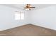 This cozy bedroom offers neutral carpet, ample natural light, and a ceiling fan for added comfort at 1037 E Dust Devil Dr, San Tan Valley, AZ 85143