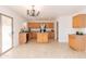 Open kitchen showcasing ample wood cabinetry and a breakfast bar, ideal for culinary adventures and casual dining at 1037 E Dust Devil Dr, San Tan Valley, AZ 85143
