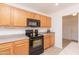 Spacious kitchen featuring modern appliances, wood cabinetry, and ample counter space at 1037 E Dust Devil Dr, San Tan Valley, AZ 85143