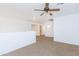 Comfortable loft with ceiling fan, neutral walls, and carpet provides a versatile space at 1037 E Dust Devil Dr, San Tan Valley, AZ 85143