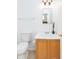 This powder room offers a single vanity, modern lighting, and a neutral color palette at 1037 E Dust Devil Dr, San Tan Valley, AZ 85143