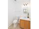 Clean powder room with a single sink vanity, modern lighting, and tiled floors at 1037 E Dust Devil Dr, San Tan Valley, AZ 85143