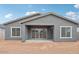 Rear exterior displaying the covered patio, picture windows and stucco at 11432 E Utopia Ave, Mesa, AZ 85212
