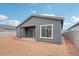 Rear exterior showcasing the covered patio, large window and block wall at 11432 E Utopia Ave, Mesa, AZ 85212