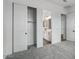 A bedroom boasts a closet with sliding doors and a bathroom with a sink and vanity at 11432 E Utopia Ave, Mesa, AZ 85212