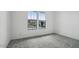 Bright bedroom featuring neutral carpet and two windows to the outside at 11432 E Utopia Ave, Mesa, AZ 85212