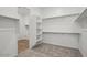 Spacious walk-in closet provides ample storage with built-in shelving and clothing rods for organized living at 11432 E Utopia Ave, Mesa, AZ 85212
