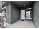 Covered entryway featuring stone accents, gray walls, and modern design elements at 11432 E Utopia Ave, Mesa, AZ 85212