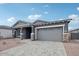 Charming single-Gathering home showcasing a gray exterior, brick accents, and a paved driveway at 11432 E Utopia Ave, Mesa, AZ 85212