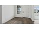 Bright foyer with wood-look tile flooring, white trim, and neutral paint at 11432 E Utopia Ave, Mesa, AZ 85212