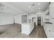 A stylish kitchen features white cabinets, a center island with quartz countertops, and stainless steel appliances at 11432 E Utopia Ave, Mesa, AZ 85212