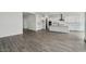 Open living area with sleek tile flooring, white walls, and a modern kitchen at 11432 E Utopia Ave, Mesa, AZ 85212