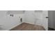 A utility room with wood-style floors leads to a carpeted walk-in closet at 11432 E Utopia Ave, Mesa, AZ 85212