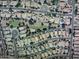 An aerial view shows a residential neighborhood featuring single-Gathering homes, a green common area, and well-maintained streets at 1147 E Lodgepole Dr, Gilbert, AZ 85298
