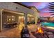 Cozy backyard patio with a fire pit, dining area, and comfortable seating, perfect for outdoor gatherings at 1147 E Lodgepole Dr, Gilbert, AZ 85298