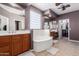 Luxurious primary bathroom with a soaking tub, double vanities, and a separate walk-in shower at 1147 E Lodgepole Dr, Gilbert, AZ 85298
