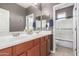 Bathroom with a double sink vanity and a shower over the tub at 1147 E Lodgepole Dr, Gilbert, AZ 85298
