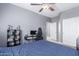 Neutral bedroom with a ceiling fan, a desk, and a closet with white doors at 1147 E Lodgepole Dr, Gilbert, AZ 85298