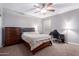 Bedroom featuring carpet, a ceiling fan, a bed, and a desk area at 1147 E Lodgepole Dr, Gilbert, AZ 85298