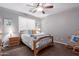 Bedroom with carpet, a ceiling fan, a bed, and a rocking chair at 1147 E Lodgepole Dr, Gilbert, AZ 85298