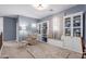 Comfortable sitting area with built-in bookshelves, plush armchair, window seat and a neutral rug at 1147 E Lodgepole Dr, Gilbert, AZ 85298