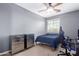Bedroom featuring carpet, a ceiling fan, and two chrome chests of drawers at 1147 E Lodgepole Dr, Gilbert, AZ 85298