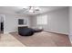 Bonus room with carpet, a ceiling fan, a TV, and two beanbag chairs at 1147 E Lodgepole Dr, Gilbert, AZ 85298