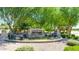 Welcoming Petty Farms community entrance with stone signage, landscaped greenery, and decorative fencing at 1147 E Lodgepole Dr, Gilbert, AZ 85298