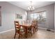 Well-lit dining room with a classic chandelier and view of the backyard at 1147 E Lodgepole Dr, Gilbert, AZ 85298