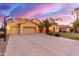 Beautiful stucco home with a three-car garage, well-manicured lawn, and desert landscaping at 1147 E Lodgepole Dr, Gilbert, AZ 85298