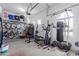 Organized garage featuring ample storage, bike racks, and a well-equipped home gym setup at 1147 E Lodgepole Dr, Gilbert, AZ 85298