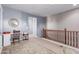 Cozy hallway with a built-in desk, a globe, a round mirror, and a wooden railing at 1147 E Lodgepole Dr, Gilbert, AZ 85298