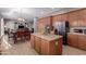 Well-equipped kitchen with a large island, stainless steel refrigerator, and open flow to the living area at 1147 E Lodgepole Dr, Gilbert, AZ 85298