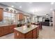 Open concept kitchen with an island, granite countertops, stainless steel appliances, and views of the dining area at 1147 E Lodgepole Dr, Gilbert, AZ 85298