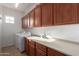 Laundry room with washer, dryer, countertop and lots of storage cabinets at 1147 E Lodgepole Dr, Gilbert, AZ 85298