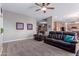 Comfortable living room with carpet, a ceiling fan, and plush leather seating at 1147 E Lodgepole Dr, Gilbert, AZ 85298